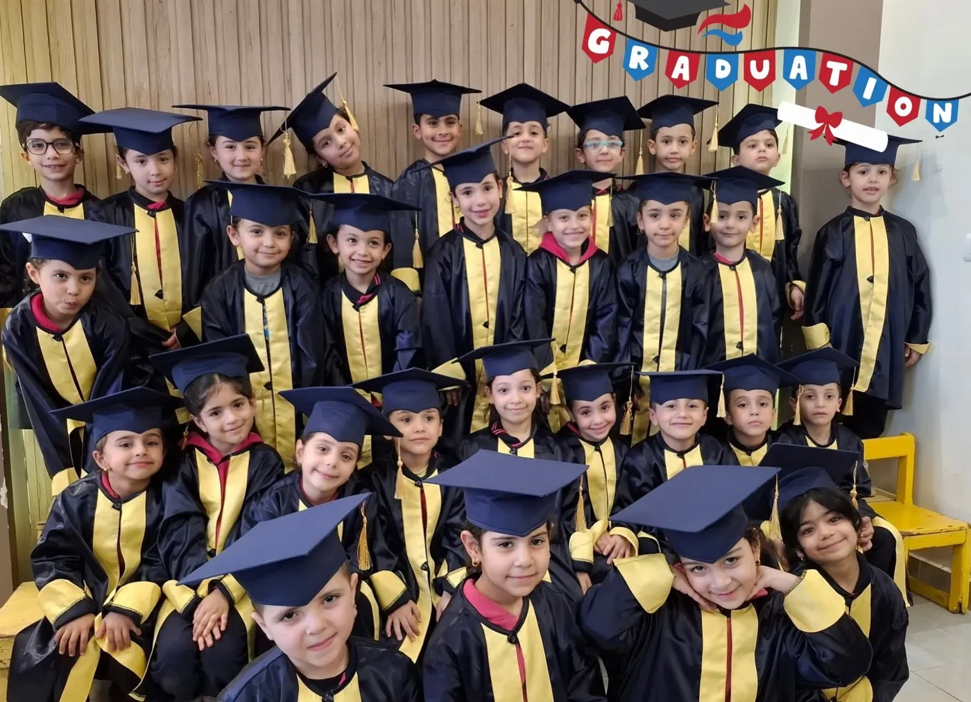 أطفال KG2 بأرواب وقبعات التخرج